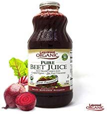 a bottle of beet juice next to some sliced radishes on a white background