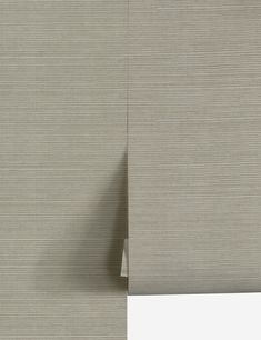 the side of a beige wall with vertical blinds