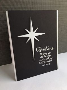 a black and white christmas card with a star on it