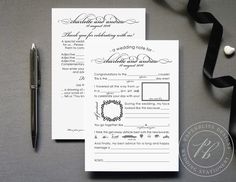 the wedding certificate is next to a pen and some black ribbon on a gray surface