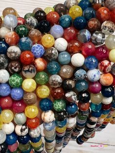 many different colored beads are stacked on top of each other