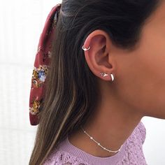 a close up of a person wearing ear rings