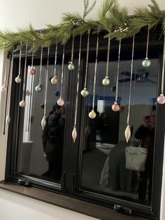 a window with ornaments hanging from it's side