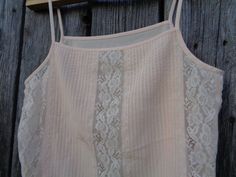 "This is a beautiful spaghetti strap top made of polyester fabric in pale peach color. Complemented with Nylon lace. Brand: St Michael made in the U.K. In excellent condition and comes from smoke-free home. Size M Labelled as size UK 14 (Eur 40; US 10) To fit bust ~36\" / 91cm Thanks for visiting my shop! OLaLaVintage Please visit my other Etsy shop of beautiful handmade items: https://www.etsy.com/shop/MilaStyle" Feminine Summer Camisole With Lace Bodice, Summer Camisole With Lace Bodice, Summer Lace Bodice Camisole, Cream Camisole With Built-in Bra And Spaghetti Straps, Summer Lace Bodice Tops With Spaghetti Straps, Cream Camisole With Adjustable Spaghetti Straps, Spring Lace Bodice Camisole With Spaghetti Straps, Spring Lace Bodice Camisole, Summer Lace Camisole Top With Adjustable Straps