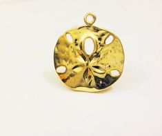 This vermeil sand dollar charm measures about 18mm in diameter. It is perfect for bracelet, necklace and earrings. It is 18k gold plated over 925 sterling silver (vermeil), shiny  gold.925 stamped in the back.1 pc.silver version: Listing: http://www.etsy.com/listing/114478741/925-sterling-silver-oxidized-sand-dollarmatte vermeil version: Listing: http://www.etsy.com/listing/150706144/vermeil18k-gold-over-925-sterling-silverFor the larger quantity convo us.Thanks for stopping by! Tarnish Resistant Gold Jewelry For Beach, Gold Round Jewelry For The Beach, Gold Round Jewelry For Beach, Gold Round Beach Jewelry, Gold Pendant Jewelry For Beach, Gold Round Pendant Jewelry For The Beach, Tarnish Resistant Gold Beach Jewelry, Gold Jewelry With Starfish Charm For Beach, Gold Sterling Silver Jewelry With Starfish Charm