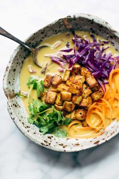 a bowl filled with noodles, meat and veggies