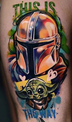 star wars tattoo on the back of a man's leg with an image of baby yoda