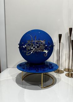 a blue object with writing on it sitting on a table next to other metal objects