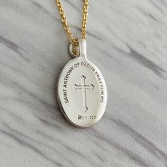 "St. Anthony of Padua is known among Christians as the Patron Saint of lost articles. It is believed that prayers to Saint Anthony give a spirit of hope and optimism to finding lost articles whether they be tangible or intangible. Premium Sterling Silver Chain Included: Includes our signature sterling silver 925 chain that is offered in 16\", 18\", 20\", or 24\". Pendant Length: 22 mm Pendant Width: 16 mm Free shipping available on all orders. Materials & Crafting: We are known for our quali Spiritual Oval Jewelry For Commemoration, Oval Spiritual Jewelry For Commemoration, Engraved White Gold Jewelry For Commemoration, Engraved Cross Necklace For Commemoration, Engraved Oval Pendant Necklace For Commemoration, Spiritual Hallmarked Necklaces For Memorials, Spiritual Necklaces With Engraving Option For Commemoration, White Gold Spiritual Necklaces For Commemoration, Spiritual White Gold Necklaces For Commemoration