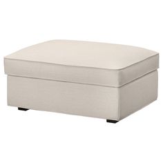 a white ottoman sitting on top of a wooden table