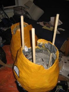 a yellow bag filled with lots of silver foil and wooden sticks sticking out of it