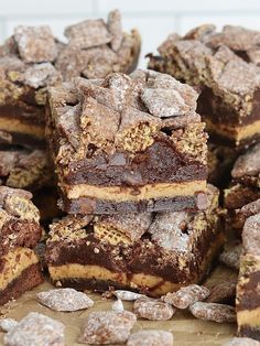 a pile of brownies sitting on top of a wooden table