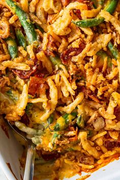 a casserole dish with green beans, bacon and cheese in it on a white plate