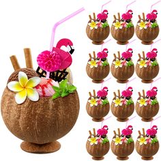 there are many coconuts with flowers and flamingos in the cup on them,