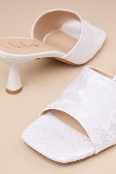 You'll be obsessed with the amount of compliments coming your way when you step out wearing the Lulus Maeler White Lace High Heel Slide Sandals! These ultra-romantic, lace-covered heels feature a trendy square footbed and an extra-wide vamp strap. A sculpted kitten heel completes the sleek slide-on design. 2. 5" sculpted heel. Lightly cushioned insole. Felted rubber sole has nonskid markings. Man made materials. Imported. Lulus | Maeler White Lace High Heel Slide Sandal Heels | Size 9.