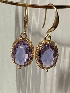 18k gold plated lilac purple lavender crystal diamanté ornate deep set oval crystal cabochon drop charm earrings many others colours in the range  The earwires are nickel free,18k gold rhodium plated on a copper base metal Elegant Amethyst Dangle Crystal Earrings, Elegant Oval Gold-plated Jewelry, Elegant Lavender Crystal Dangle Earrings, Elegant Oval Gold Plated Jewelry, Elegant Lavender Dangle Crystal Earrings, Exquisite Purple Jewelry For Gifts, Elegant Purple Cubic Zirconia Crystal Earrings, Purple Oval Fine Jewelry Earrings, Elegant Purple Crystal Earrings