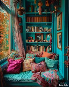 a room filled with lots of books and pillows on top of a window sill