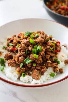 a white plate topped with meat and rice