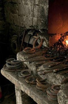 there are many different types of tools on the table in front of the fire place