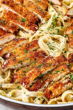 chicken alfredo in a pan with parsley on top