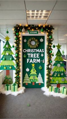 an office decorated for christmas with green trees and presents on the front door that says christmas tree farm