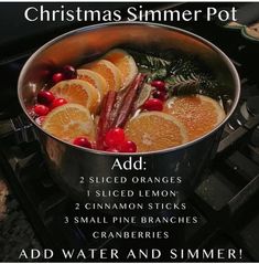 a pot filled with orange slices and cranberries