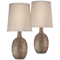 two lamps are sitting next to each other on a white background, one is brown and the other is beige