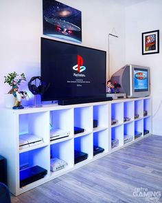 an entertainment center with video game consoles and games on the shelves in front of it