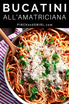 a pan filled with pasta and parmesan cheese on top of a striped cloth