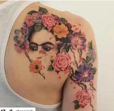 a woman's shoulder with flowers on it