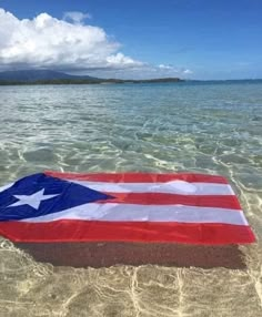 an american flag is floating in the water