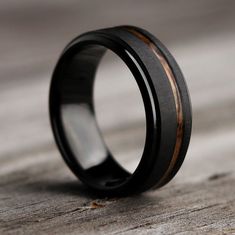 black ceramic ring with wood inlays on top