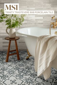 a white bath tub sitting next to a wooden stool