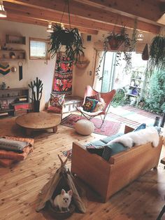 a living room filled with furniture and lots of plants