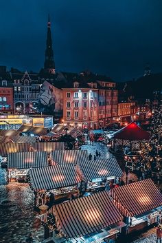 the christmas market is lit up at night