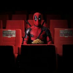 deadpool is sitting in the movie theater