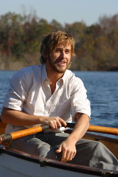 a man sitting in a boat on the water