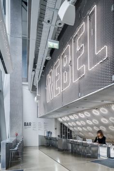 the inside of a building with people sitting at tables