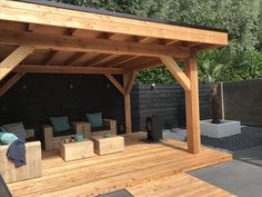 an outdoor living area with wooden furniture and seating