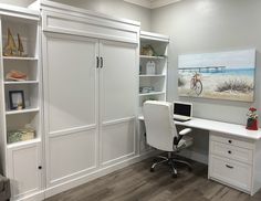 a white desk and chair in a room with built - in bookcases, cabinets, and drawers