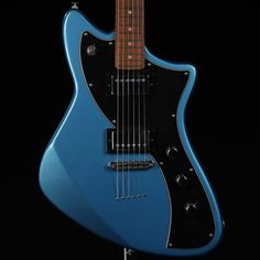 a blue electric guitar is shown against a black background with the strings still attached to it