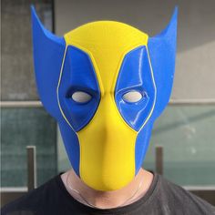 a man wearing a yellow and blue mask