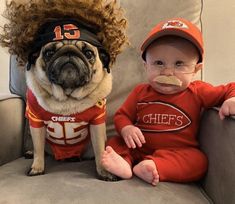 a baby sitting on a couch next to a dog wearing a football shirt and hat