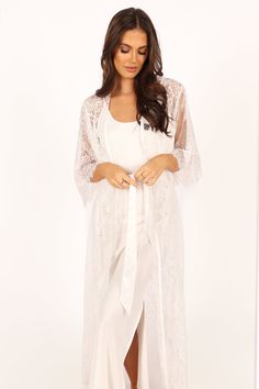 DETAILS
  This soft floral lace robe is the perfect addition to your lingerie wardrobe. With a long length style and relaxed sleeves, it's perfect for those romantic nights in or out on the town. The wrap front design of this luxurious robe ensures a flattering fit, while the detachable waist tie provides extra security and comfort.

soft floral lace robe
long length style robe
long lace sleeves
wrap front design
detachable waist tie
unlined

material - 100% polyester









SIZING

model is 5 Elegant Long Sleeve Lace Sleepwear, Lace Long Sleeve Sleepwear For Wedding Night, Long Lace Robe For Wedding Night, White Long-length Sleepwear For Loungewear, White Lace Sleepwear For Loungewear, Feminine Long Sleeve Lace Sleepwear, Delicate Lace Robe For Wedding Night, Feminine Lace Robe For Wedding Night, White Lace Robe With Delicate Details