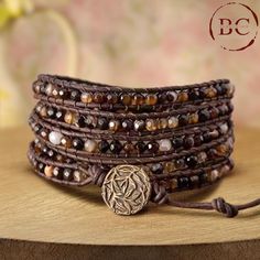 Embrace a sophisticated bohemian vibe with this exclusive wrap bracelet, featuring coffee onyx and agate beads meticulously arranged for a striking look. Designed for both women and men, this bracelet is crafted with five layers of high-quality leather, each adorned with rich, earthy coffee onyx and agate beads. The dark, coffee-colored onyx beads are complemented by the unique patterns and hues of agate, creating a harmonious blend of natural textures and tones. The leather bands are intricately woven to securely hold the beads, offering a durable and comfortable fit. The bracelet is finished with antique bronze plating, which enhances its vintage charm and adds a timeless, classic touch to the design. The antique bronze accents provide a rich contrast to the deep, warm colors of the bead Bohemian Brown Agate Beaded Bracelets, Elegant Brown Beaded Wrap Bracelet, Spiritual Brown Beaded Wrap Bracelet, Brown Gemstone Beads Wrap Bracelet Gift, Brown Hand Wrapped Wrap Bracelet As Gift, Brown Hand Wrapped Spiritual Wrap Bracelet, Brown Hand Wrapped Wrap Bracelet Gift, Adjustable Brown Spiritual Wrap Bracelet, Brown Spiritual Wrap Bracelet With Natural Stones