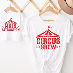 two t - shirts that say circus crew and main attraction hanging on a clothes rack