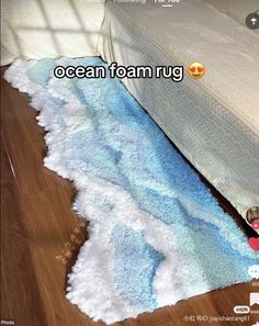 an ocean foam rug on the floor next to a bed