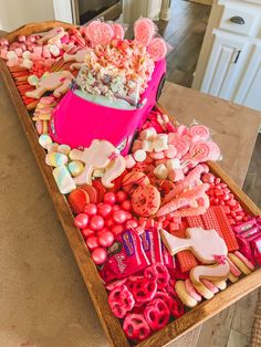 a tray filled with lots of candy and cookies