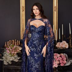 The Magnificent Dress Made In The Silhouette Of The Sheath Has A Removable Mesh Cape That Gives The Image Uniqueness. This Product Has A Delicate Heart-Shaped Bodice That Is Decorated With Beautiful Floral Appliques And Sequins As Well As The Entire Perimeter Of The Dress. Length: Long Colour: Navy Neckline: Off Shoulder Silhouette: Sheath Sleeve: Sleeveless Skirt: Floor Length Embellishments: Sequins, Floral Applique Occasion: Romantic Date/Evening/Dinner, Wedding/Bridesmaid, Graduation, Fashio Gown With Cape, Evening Gala, Lace Cape, Cape Gown, Strapless Prom Dress, Cinderella Divine, Fairy Dresses, Printed Gowns, Fashion Gowns