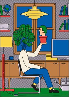 a person sitting at a desk with a potted plant in front of him and a lamp above them